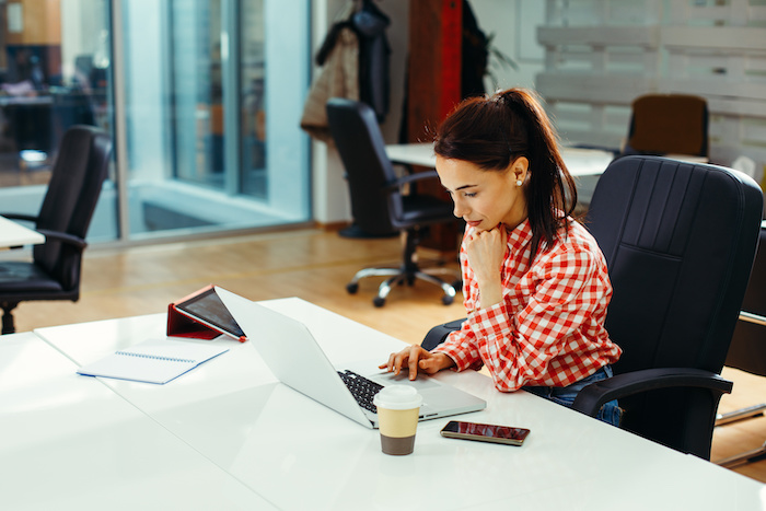 Young woman working on laptop in the office